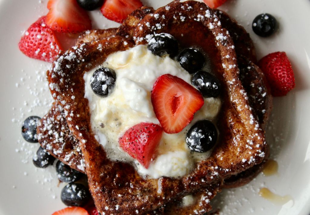 Golden French toast served with berries for breakfast.